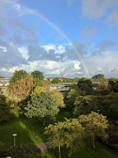 Rainbow after a shower in an autumn cityscape