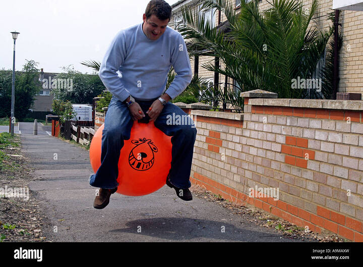 grown-man-on-space-hopper-A9MAXW-3770970734
